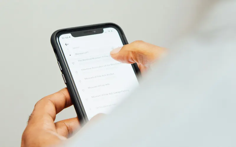 Someone searching for a trip on a phone